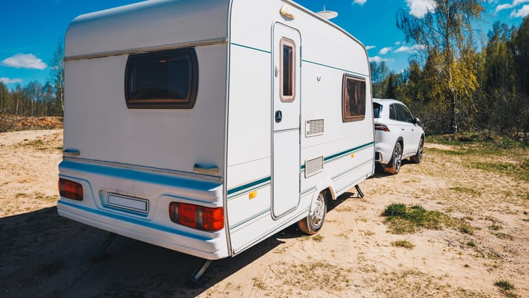 white-trailer-caravan-car-is-parked-on-the-side-of-road